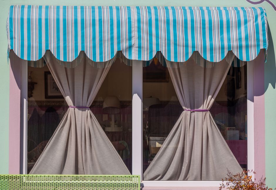 Elegant fabric window shades pulled halfway down